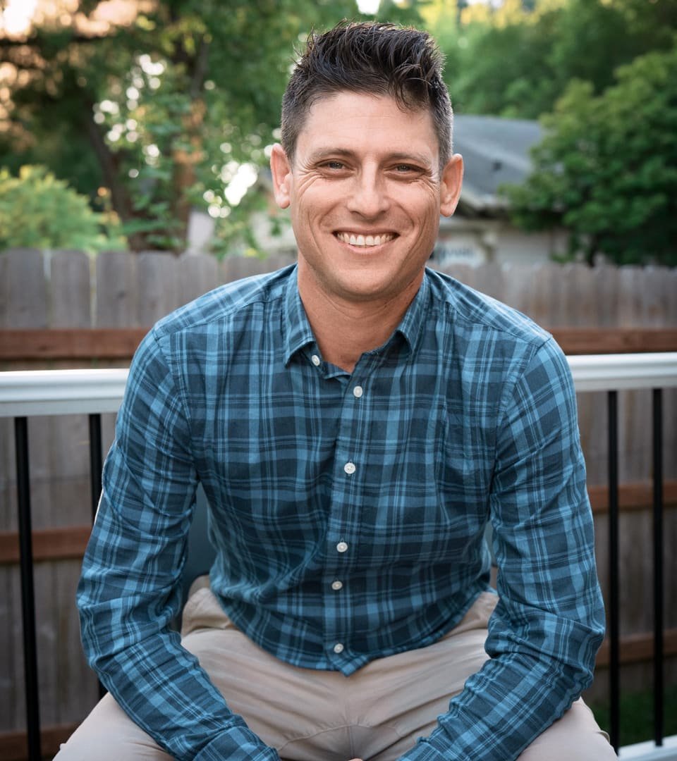 Dr. Jared Dubey seated outdoors, smiling
